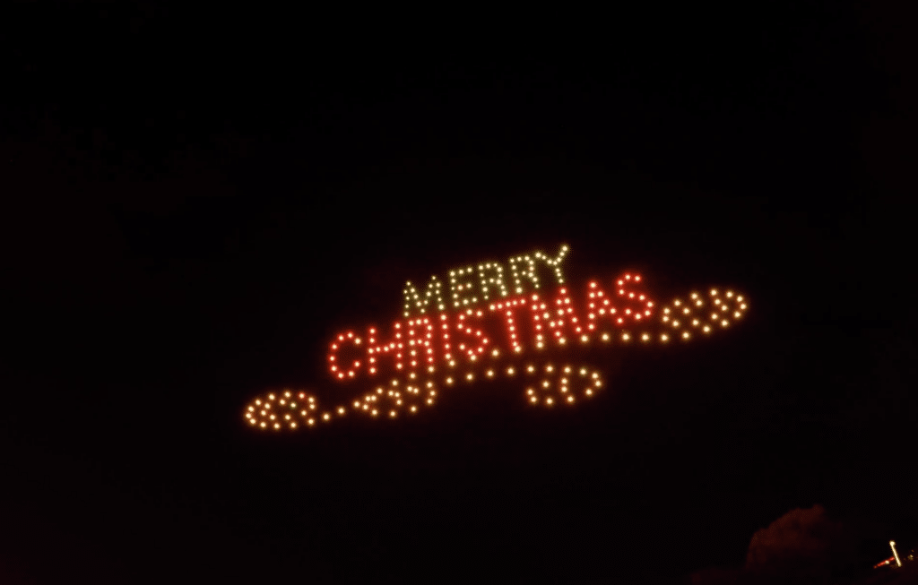 Merry Christmas lights sign against dark sky