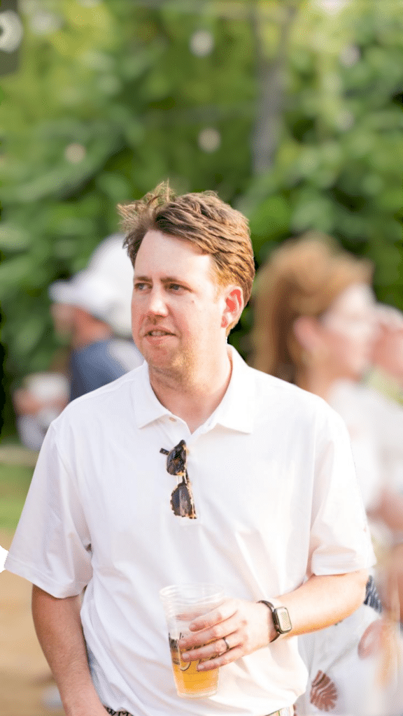 Man holding beer at outdoor event