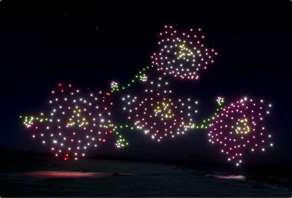 Illuminated drone light show forming shapes in night sky