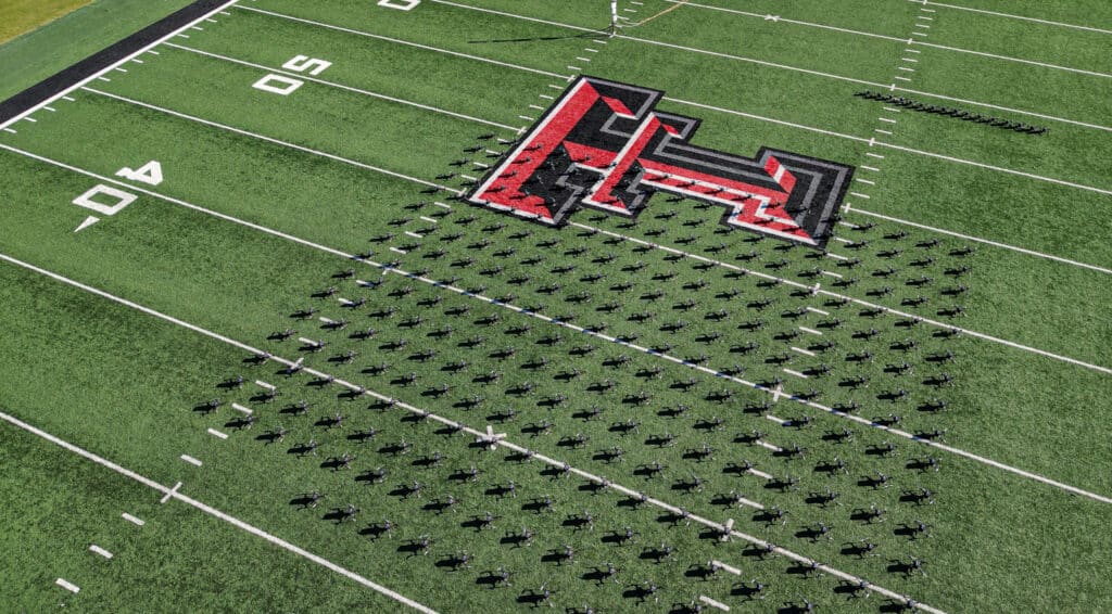 Marching band forms giant red letter 'H' on field