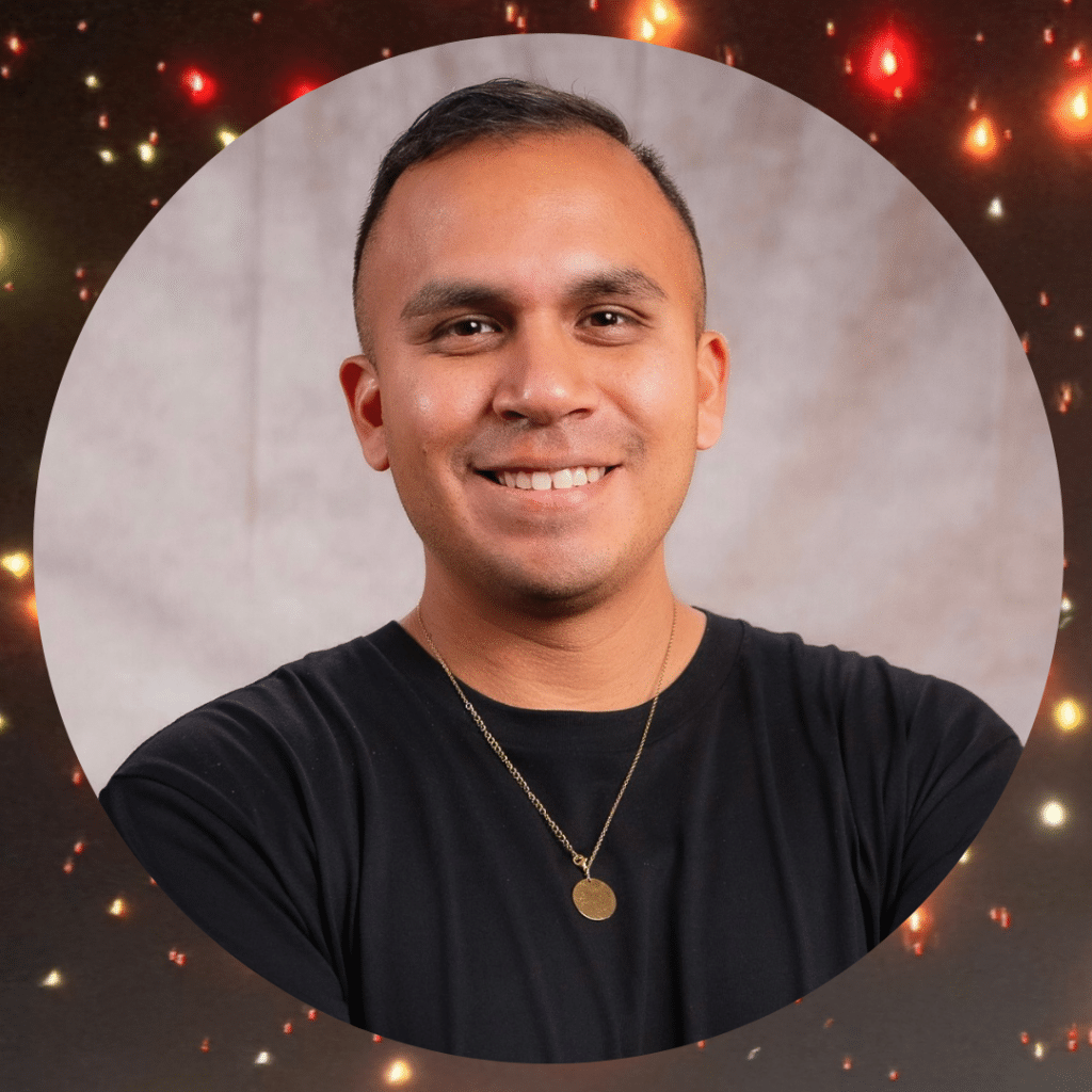 Smiling man with twinkling lights background